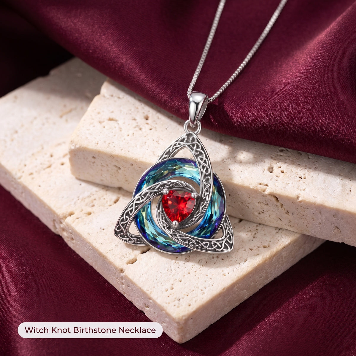 Witch Knot Birthstone Necklace on travertine and wine silk