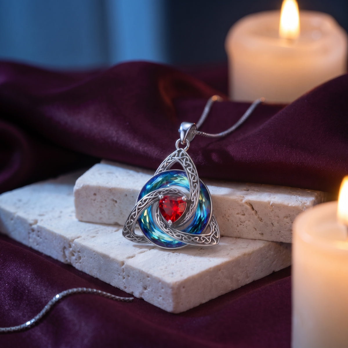 Witch knot pendant on travertine and wine velvet by candlelight